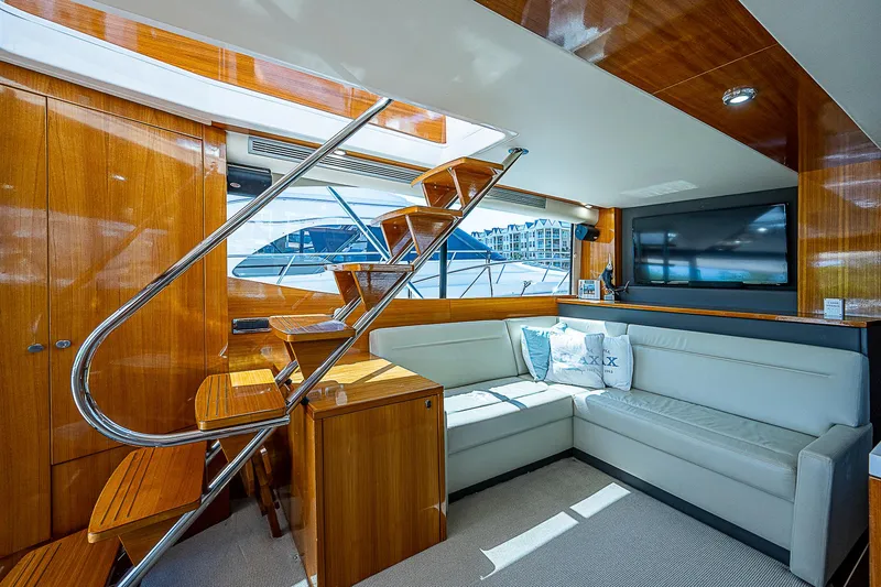 Slide: The Image of 2014 Maritimo 470 Offshore Convertible cruising under a bridge on open water. - 7