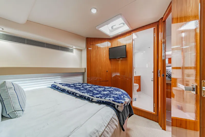 Slide: The Image of 2014 Maritimo 470 Offshore Convertible yacht docked in a scenic marina. - 70