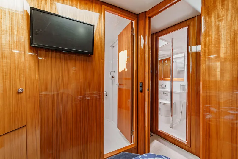 Slide: The Image of 2014 Maritimo 470 Offshore Convertible yacht cruising near modern waterfront architecture. - 71