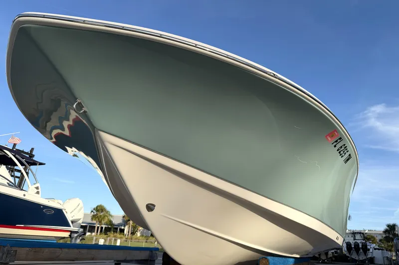 Slide: The Image of 2023 Tidewater 2410 Bay Max boat, docked under clear blue sky. - 10