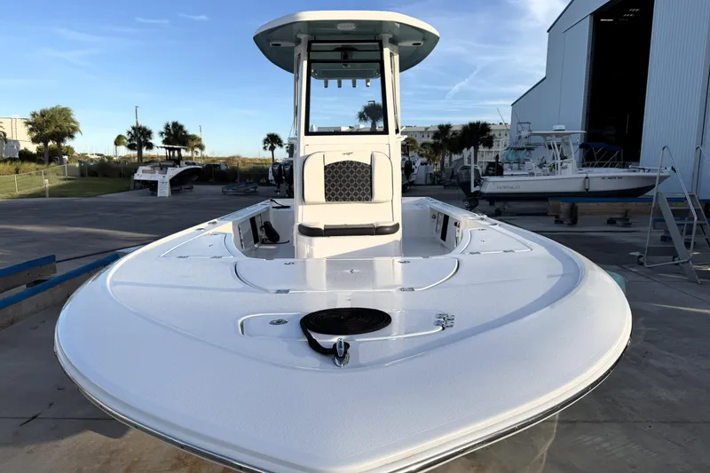 Slide: The Image of 2023 Tidewater 2410 Bay Max boat docked near a marina, showcasing sleek design. - 11