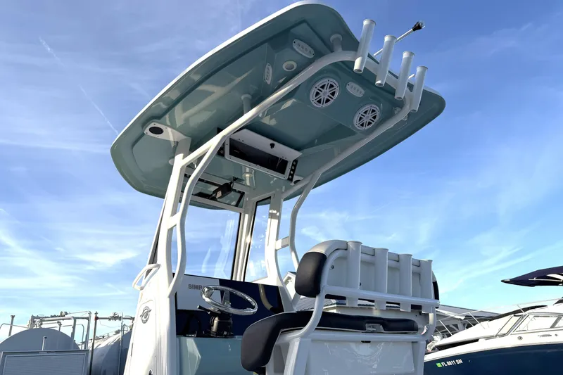 Slide: The Image of 2023 Tidewater 2410 Bay Max boat with T-top and rod holders under clear sky. - 14