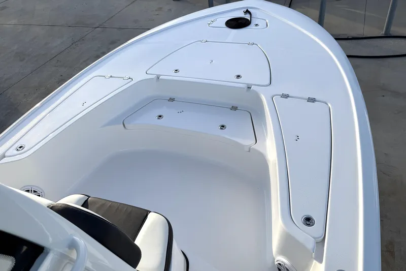 Slide: The Image of 2023 Tidewater 2410 Bay Max boat interior with storage compartments and seating. - 22