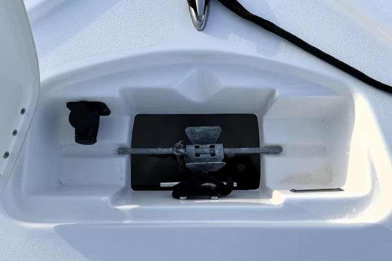 Slide: The Image of Anchor compartment of 2023 Tidewater 2410 Bay Max boat, featuring a neatly stored anchor. - 24