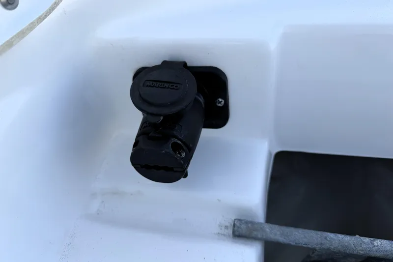 Slide: The Image of 2023 Tidewater 2410 Bay Max boat detail with a black marine plug socket. - 25