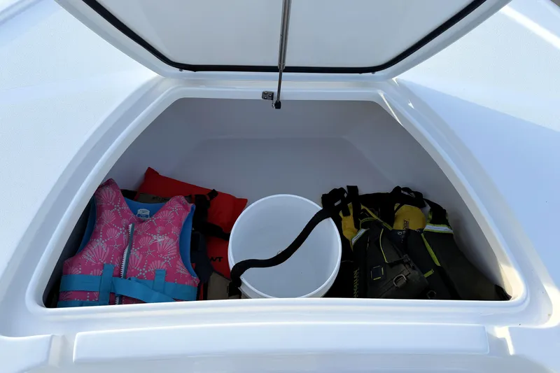 Slide: The Image of Storage compartment of 2023 Tidewater 2410 Bay Max boat with life jackets and bucket. - 26