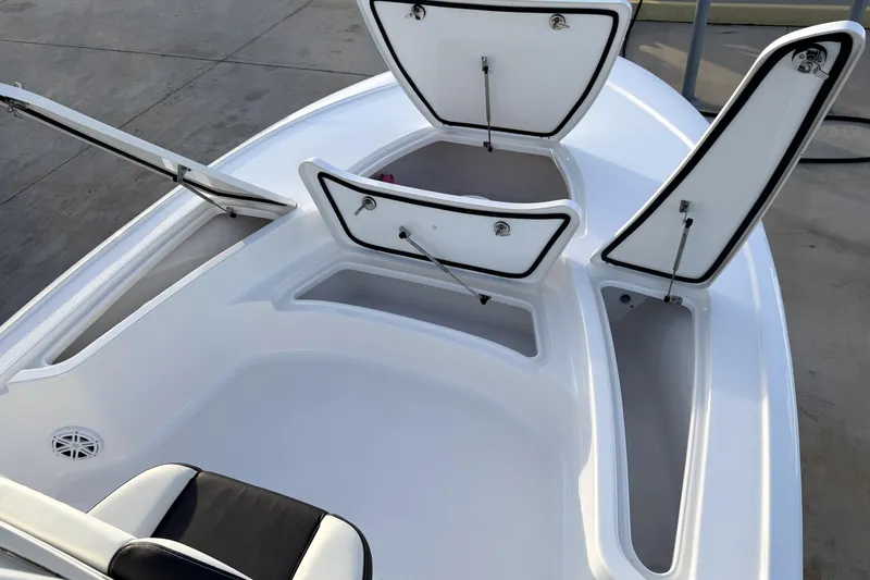 Slide: The Image of 2023 Tidewater 2410 Bay Max boat with open storage compartments on deck. - 30