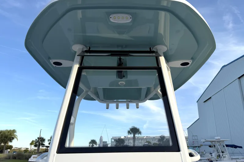 Slide: The Image of 2023 Tidewater 2410 Bay Max boat, T-top view, clear sky background. - 32
