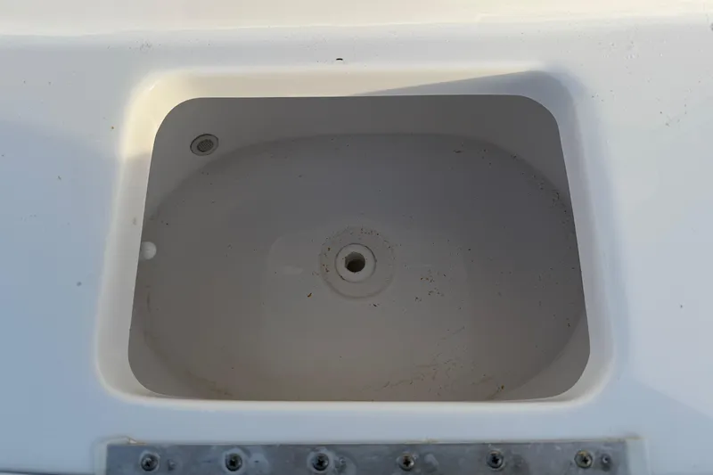 Slide: The Image of Livewell compartment on 2023 Tidewater 2410 Bay Max boat, white interior. - 33