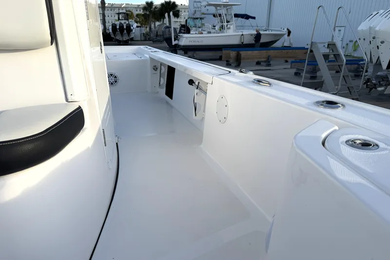 Slide: The Image of 2023 Tidewater 2410 Bay Max boat interior with sleek white design and seating. - 34