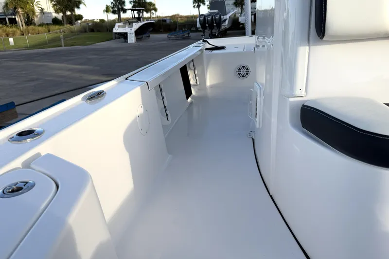 Slide: The Image of 2023 Tidewater 2410 Bay Max boat interior with seating and storage compartments. - 35