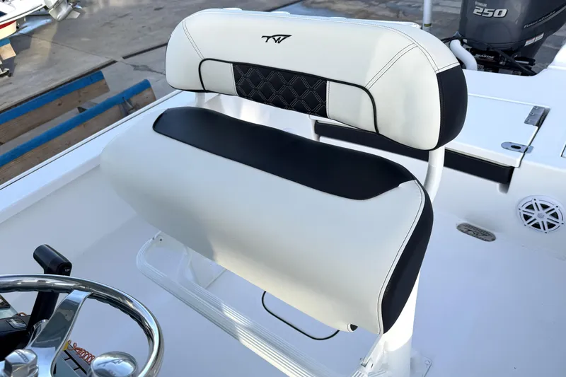 Slide: The Image of 2023 Tidewater 2410 Bay Max boat interior with sleek white and black seating. - 36