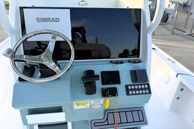 Slide: The Image of 2023 Tidewater 2410 Bay Max boat console with Simrad display and steering wheel. - 37