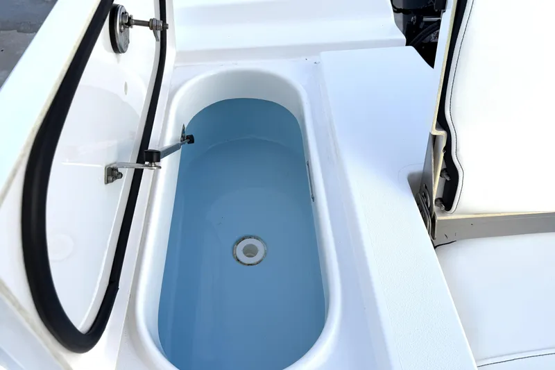 Slide: The Image of 2023 Tidewater 2410 Bay Max boat livewell with open lid and seating. - 48