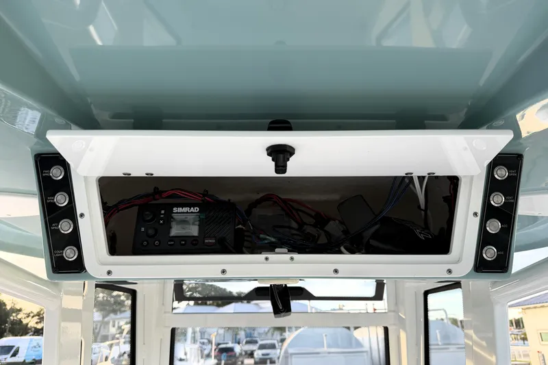 Slide: The Image of 2023 Tidewater 2410 Bay Max boat console with Simrad electronics and control panel. - 56