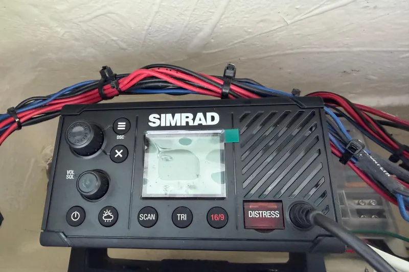 Slide: The Image of Simrad marine radio on 2023 Tidewater 2410 Bay Max boat, with visible wiring. - 57