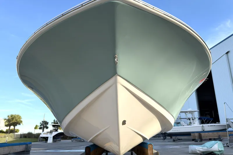 Slide: The Image of 2023 Tidewater 2410 Bay Max boat, front view, docked near a marina. - 7