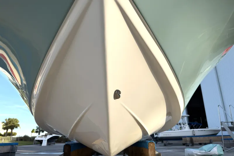 Slide: The Image of 2023 Tidewater 2410 Bay Max boat hull, close-up view in a marina setting. - 8