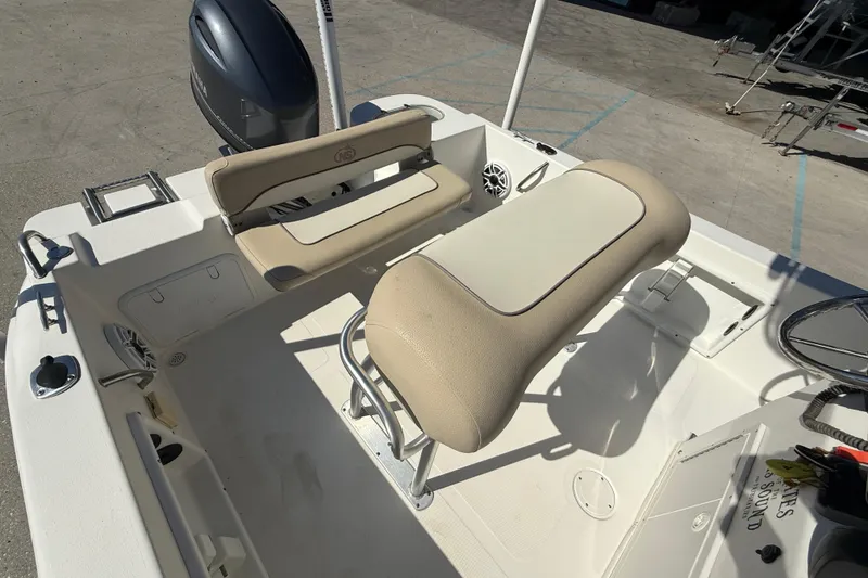 Slide: The Image of 2019 NauticStar 19 XS boat interior with seating and Yamaha outboard motor. - 11