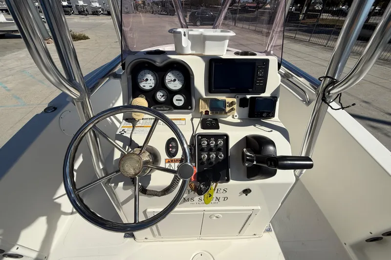 Slide: The Image of 2019 NauticStar 19 XS boat console with steering wheel and navigation instruments. - 12