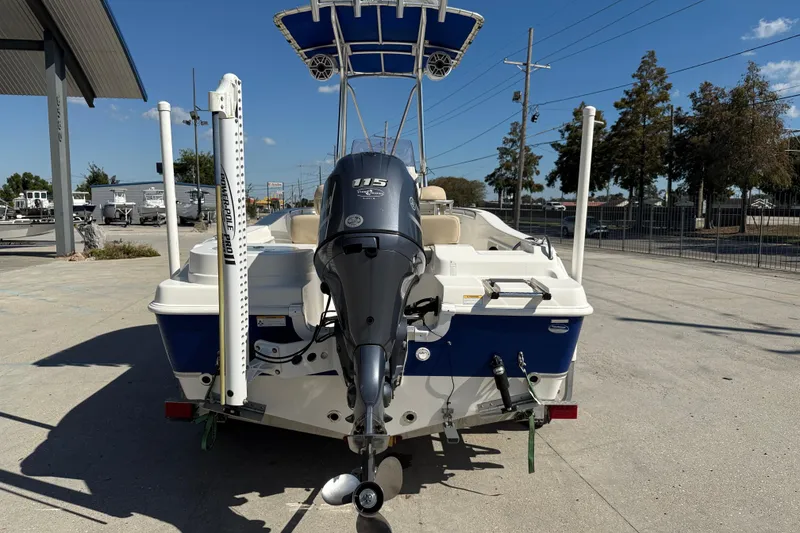 Slide: The Image of 2019 NauticStar 19 XS boat with Yamaha 115 engine, parked outdoors. - 5