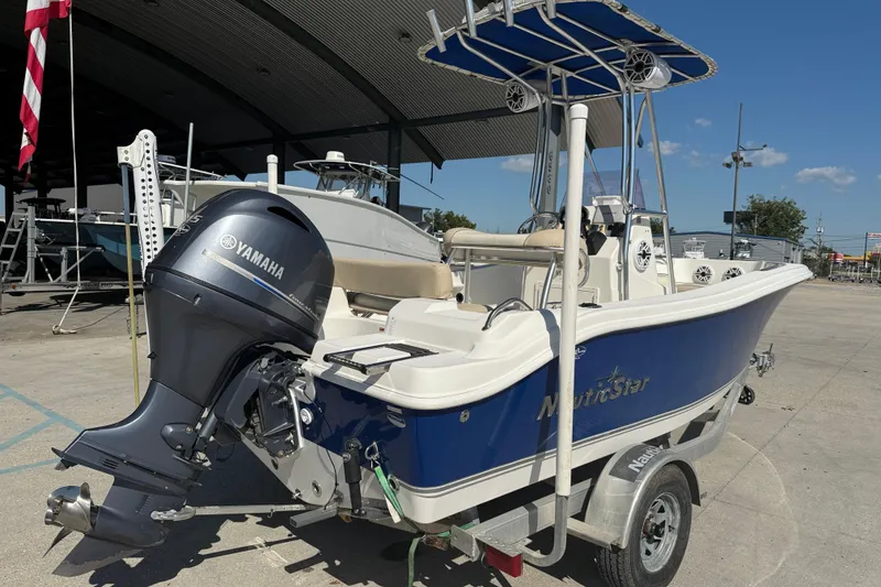 Slide: The Image of 2019 NauticStar 19 XS boat with Yamaha outboard motor on trailer. - 6