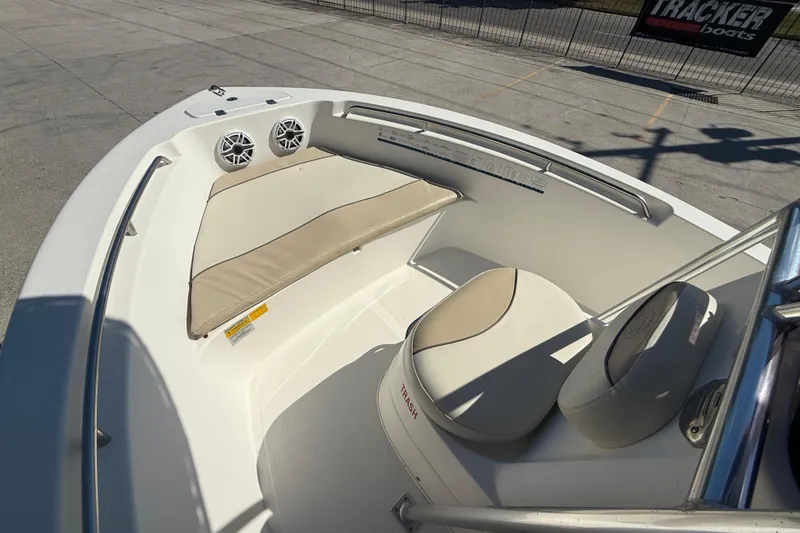 Slide: The Image of 2019 NauticStar 19 XS boat interior with cushioned seating and speakers. - 9
