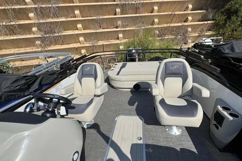 Slide: The Image of 2024 Barletta ARIA 22UC boat interior with two cushioned seats and steering console. - 11