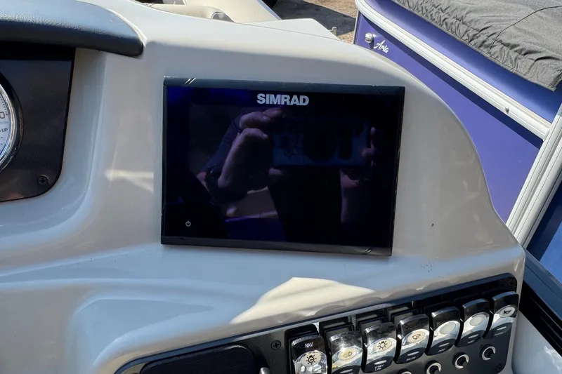 Slide: The Image of 2024 Barletta ARIA 22UC dashboard with Simrad display and control panel. - 13