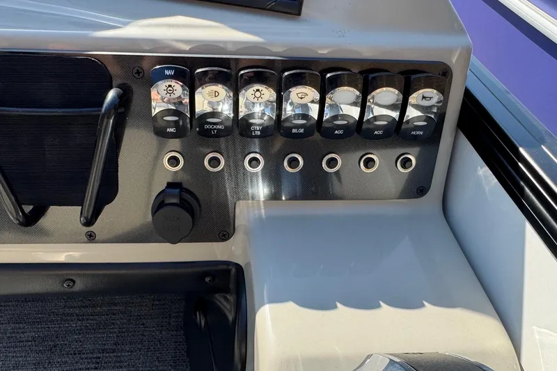 Slide: The Image of Control panel of 2024 Barletta ARIA 22UC boat with labeled switches and ports. - 14