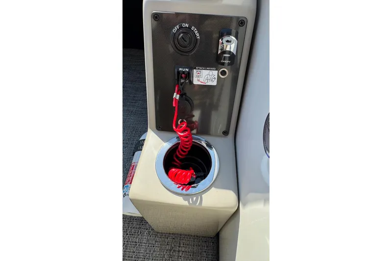 Slide: The Image of 2024 Barletta ARIA 22UC boat control panel with red coiled lanyard and ignition switch. - 15