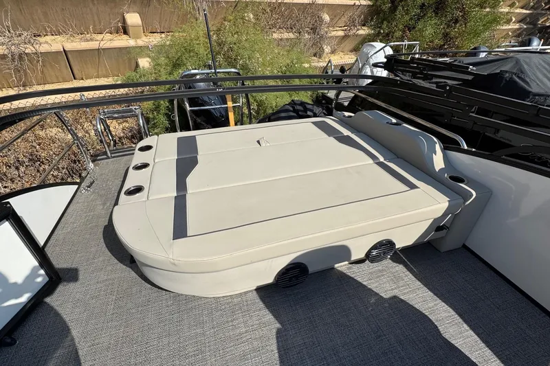 Slide: The Image of 2024 Barletta ARIA 22UC boat with spacious seating and cup holders on deck. - 18