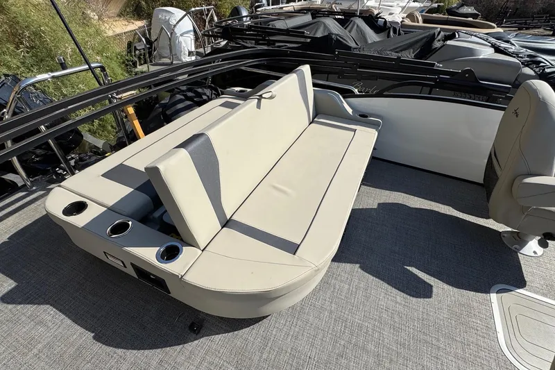 Slide: The Image of 2024 Barletta ARIA 22UC boat interior with beige seating and cup holders. - 19