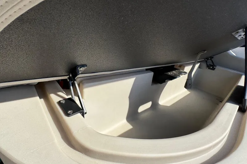 Slide: The Image of 2024 Barletta ARIA 22UC storage compartment with open lid and metal hinges. - 21