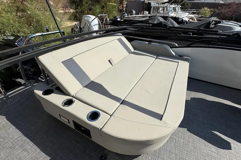 Slide: The Image of 2024 Barletta ARIA 22UC boat with beige seating and cup holders on deck. - 22