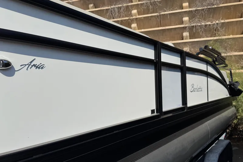 Slide: The Image of 2024 Barletta ARIA 22UC pontoon boat, sleek white and black design. - 3