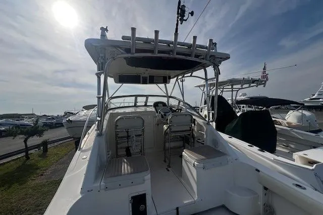 Slide: The Image of 2005 Scout 280 Abaco boat with open cockpit and seating, docked under a sunny sky. - 4