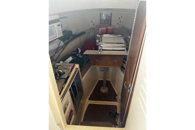 Slide: The Image of 2005 Scout 280 Abaco cabin interior with storage and seating area. - 5