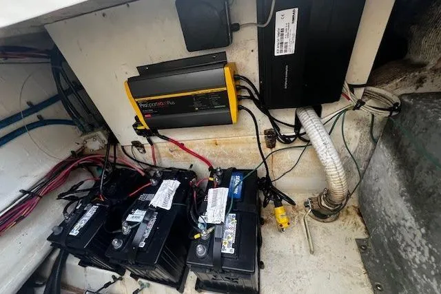 Slide: The Image of Battery compartment of a 2005 Scout 280 Abaco boat with wiring and charger. - 8