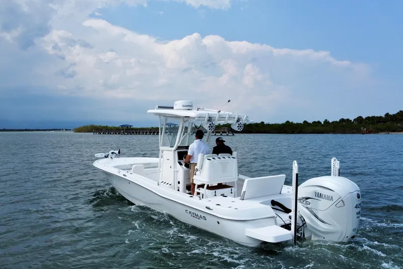The Image of 2020 Caymas 28 HB boat cruising on open water with Yamaha engine. - 0