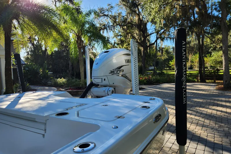Slide: The Image of 2020 Caymas 28 HB boat with Yamaha engine, parked outdoors under palm trees. - 11