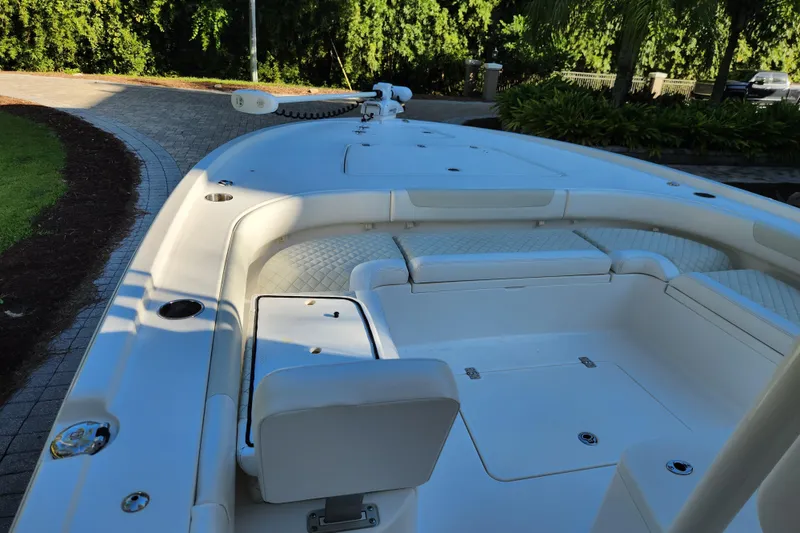 Slide: The Image of 2020 Caymas 28 HB boat interior with cushioned seating and storage compartments. - 17