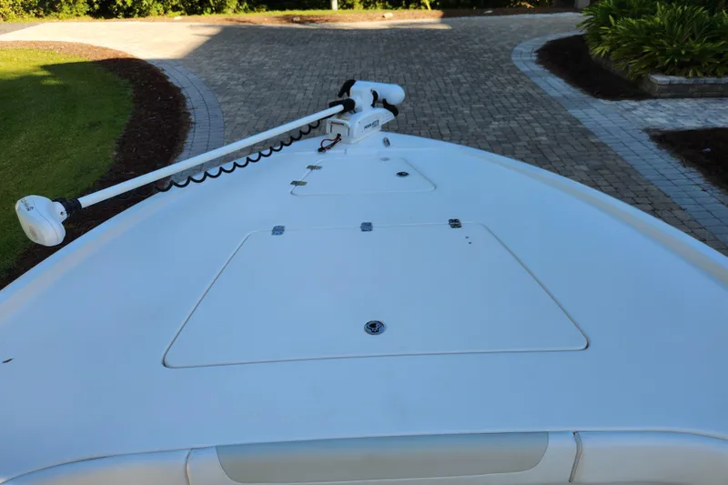 Slide: The Image of 2020 Caymas 28 HB boat bow with trolling motor on paved driveway. - 18