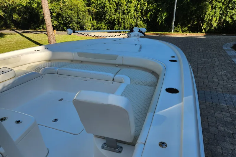 Slide: The Image of 2020 Caymas 28 HB boat interior with white seating and spacious deck. - 19