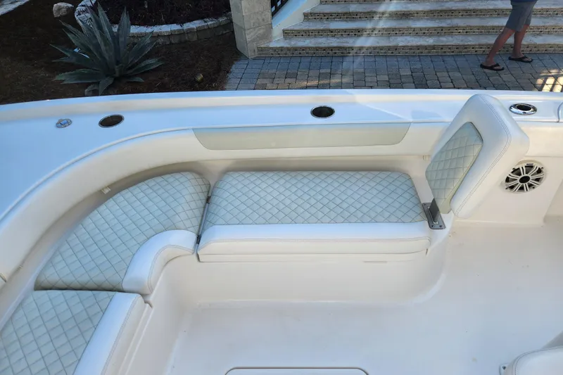 Slide: The Image of 2020 Caymas 28 HB boat interior with cushioned seating and speaker. - 20