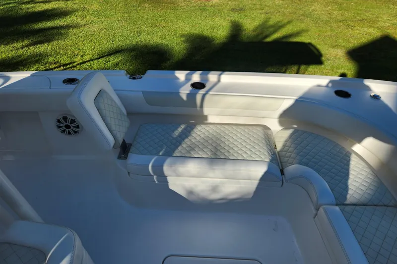 Slide: The Image of 2020 Caymas 28 HB boat interior with white quilted seating and cup holders. - 21