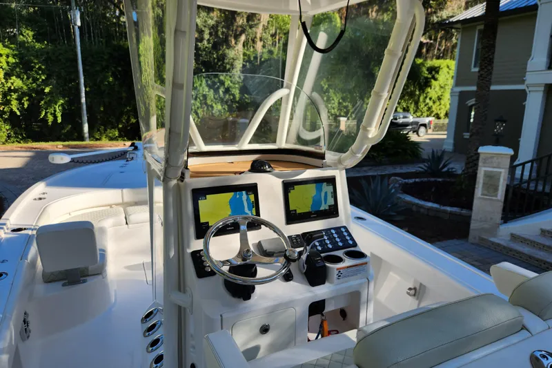 Slide: The Image of 2020 Caymas 28 HB boat cockpit with dual navigation screens and steering wheel. - 29
