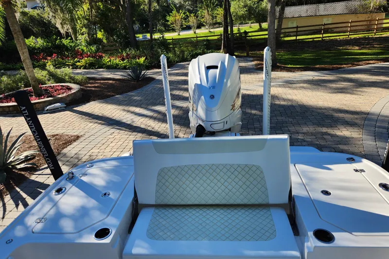 Slide: The Image of 2020 Caymas 28 HB boat with outboard motor, parked on a paved driveway. - 42