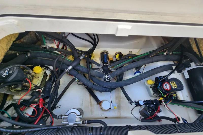 Slide: The Image of 2020 Caymas 28 HB boat engine compartment with wiring and hoses. - 46