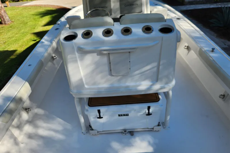 Slide: The Image of 2020 Caymas 28 HB boat interior with rod holders and Yeti cooler. - 47